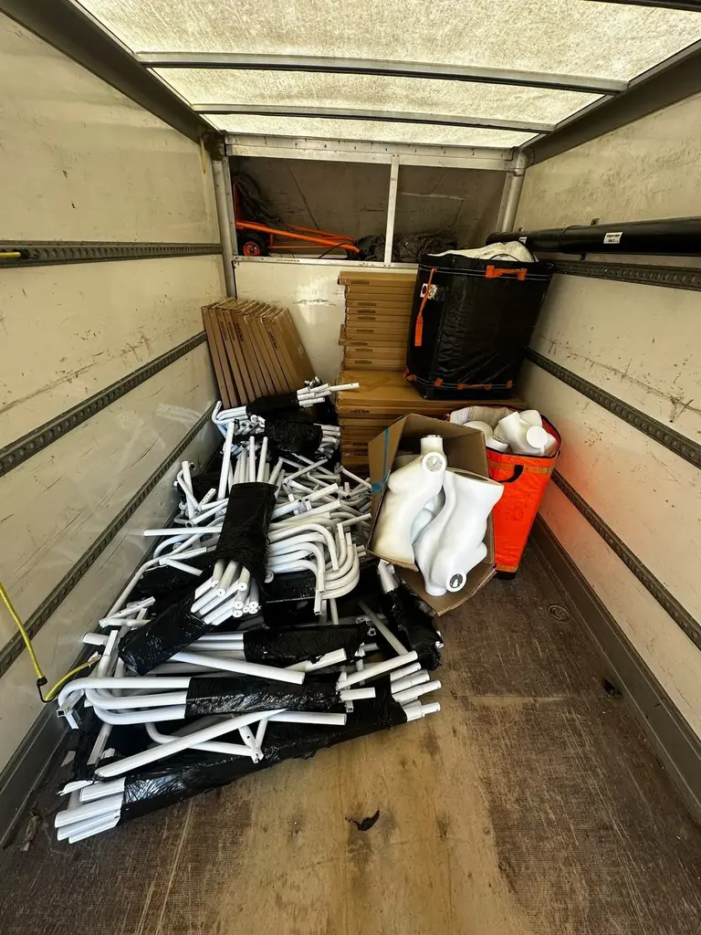 Commercial move in progress: retail display mannequins and dismantled shop fittings loaded into a 2FAST van